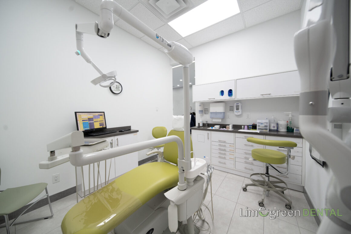 Dental shade guide held against a patient's teeth to match a cosmetic dentistry result at Limegreen Dental in Hamilton