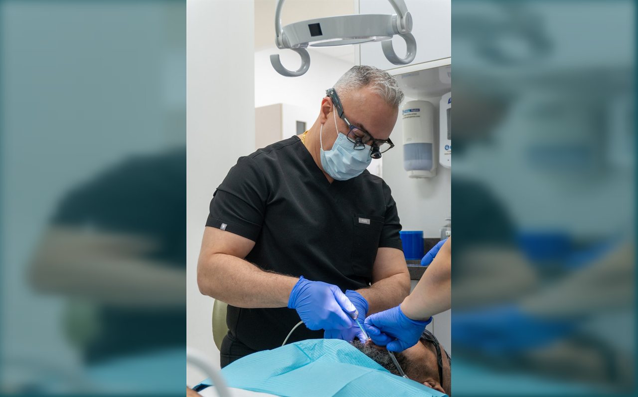 Dentist with loupes treating a patient at Limegreen Dental in Hamilton