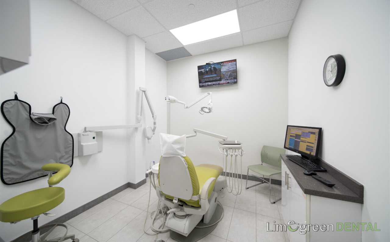 Modern treatment room with a lime green dental chair at Limegreen Dental