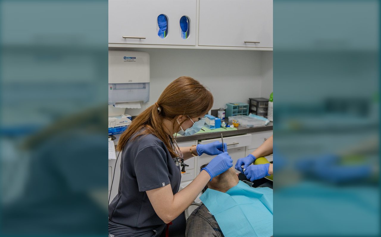 Dental hygienist caring for a patient at Limegreen Dental in Hamilton