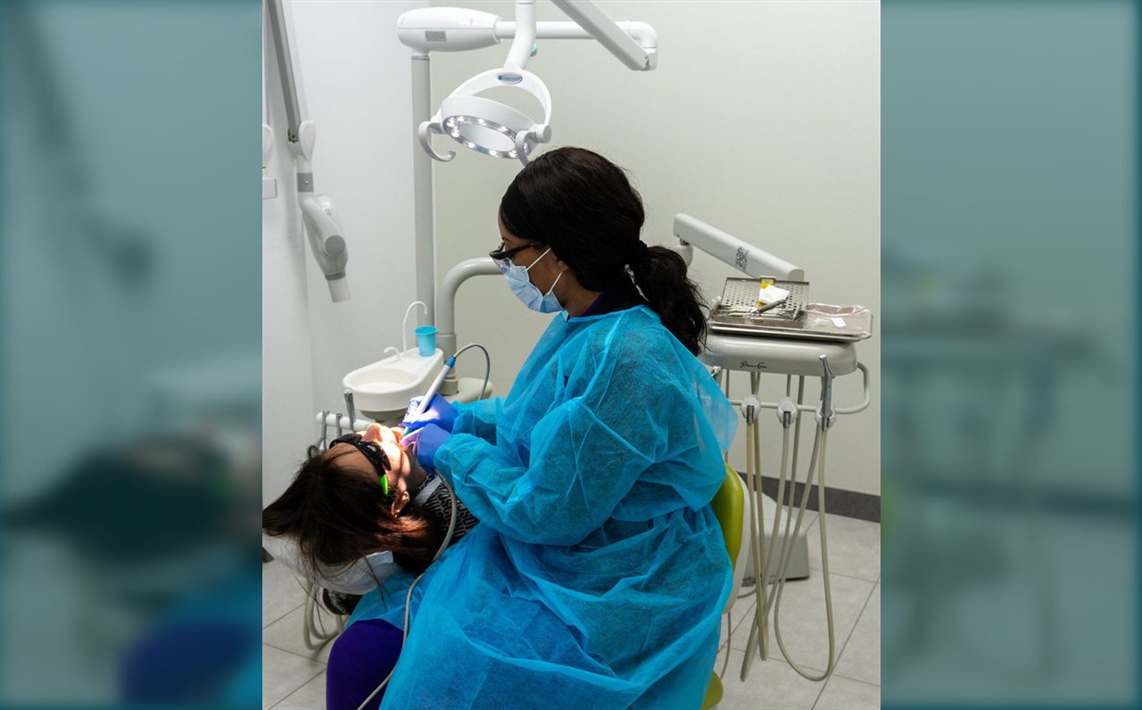 Limegreen Dental clinician during a dental procedure in Hamilton
